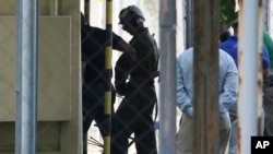 U.S. Marine Pfc Joseph Scott Pemberton, a suspect in the killing of a transgender Filipino woman, is escorted to his detention inside the compound of the Camp Aguinaldo military headquarters in suburban Quezon city, north of Manila, Philippines, Oct. 22, 2014.