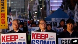 South Koreans hold banners during a rally to demand to keep the General Security of Military Intelligence Agreement, or GSOMIA, near the Foreign Ministry in Seoul, South Korea, Nov. 22, 2019.