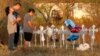 Miranda Hernandez (L) prays at sunset with father Kenneth and mother Irene at a row of crosses near the site of the shooting at the First Baptist Church of Sutherland, Texas, Nov. 6, 2017. 