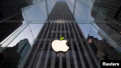 The leaf on the Apple symbol is tinted green at the Apple flagship store, 5th Avenue, New York, April 22, 2014.