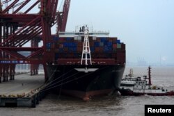 FILE - bA cargo ship is anchored at a port in Zhoushan, Zhejiang province, Feb. 14, 2016. China's exports fell 11.2 percent in January from a year earlier and imports tumbled 18.8 percent.
