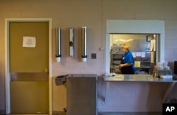 FILE- An employee cleans the hospital's cafeteria of Wedowee Hospital, in Wedowee, Alabama, July 30, 2015. Rural hospitals nationwide have struggling budgets that were propped up by the massive influx of poor people who gained taxpayer-funded health insurance.