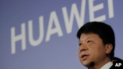 Huawei Rotating Chairman Guo Ping, center, speaks during a press conference in Shenzhen city, China's Guangdong province, Thursday, March 7, 2019. Chinese tech giant Huawei is launching a U.S. court challenge to a law that labels the company a security risk 