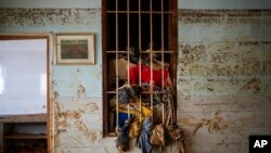 Wet clothes hangs on a window near the water level marker in an area affected by floods in Paiporta, Valencia, Spain, Nov. 5, 2024.