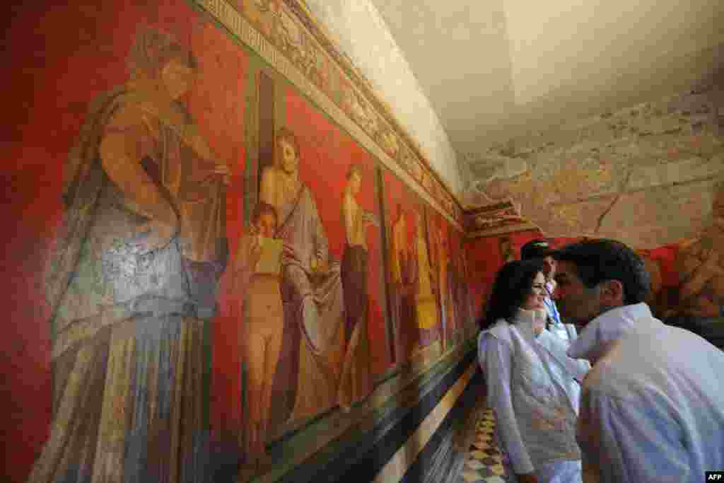 Visitors walk in the Roman Villa of the Mysteries (Villa dei Misteri) which was newly restored and re-opened to the public in the archaeological site of Pompeii, Italy.