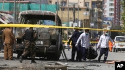 Health workers retrieve a body after an attack that targeted a bus carrying mostly government employees in Kabul, Afghanistan, June 3, 2019.