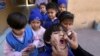 FILE - A health worker gives a polio vaccine to a child at a school in Lahore, Pakistan, Feb. 17, 2020. 