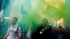 Italian League (Lega) supporters hold flares as they arrive at political rally led by leader Matteo Salvini, in Milan, Italy, Feb. 24, 2018.