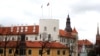 Latvian flag and presidential standard flutter over the Riga Castle, in Riga, Latvia, April 9, 2019.