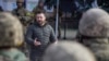 This handout photograph taken and released by Ukrainian Presidential press service on Nov. 14, 2022, shows Ukrainian President Volodymyr Zelensky speaking to servicemen during his visit to the newly liberated city of Kherson, following the retreat of Russ