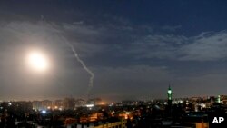 This photo released by the Syrian official news agency SANA, shows missiles flying into the sky near international airport, in Damascus, Syria, Monday, Jan. 21, 2019. 