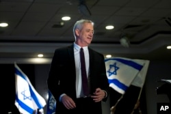 FILE - Retired Israeli general Benny Gantz, one of the leaders of the Blue and White party, prepares to deliver a speech during election campaigning for elections to be held April 9, in Ramat Gan, Israel.
