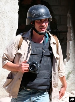 Photographer Andrei Stenin is shown working near Damascus in this 2013 provided by Syria's ITAR-TASS.
