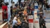 People line up to get on an Air France flight to Paris at O.R. Tambo International Airport in Johannesburg, South Africa, Nov. 26, 2021. Several nations have moved to stop air travel from southern Africa in reaction to discovery of a new COVID-19 variant in South Africa.