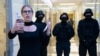 Aktivis oposisi Lyubov Sobol melaporkan secara langsung melalui telepon saat polisi berjaga-jaga selama penggerebekan di kantor Yayasan Anti-Korupsi, di Moskow, Rusia, 26 Desember 2019. (Foto: AP)