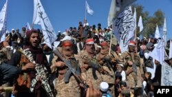 Afghan Taliban militants and villagers attend a gathering as they celebrate the peace deal in the Afghan conflict with the U.S. in Afghanistan, in Alingar district of Laghman Province on March 2, 2020. 