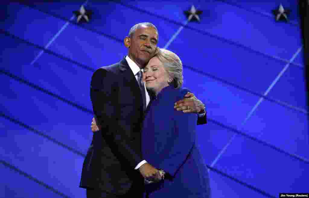 Democratic presidential nominee Hillary Clinton hugs President Barack Obama as she arrives onstage at the end of his speech on the third night of the 2016 Democratic National Convention in Philadelphia, Pennsylvania, July 27, 2016.
