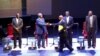 Uganda President Yoweri Museveni (with file) shakes hands with Amama Mbabazi, former prime minister, during a presidential debate in Kampala, Feb. 13, 2016.