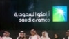 FILE - In this Dec. 11, 2019 photo, Saudi Arabia's state-owned oil company Aramco and stock market officials celebrate the debut of Aramco's initial public offering on the Riyadh Stock Market, in Riyadh, Saudi Arabia. 