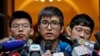 Pro-democracy activist Alex Chow, center, speaks to reporters outside the Court of Final Appeal in Hong Kong, Feb. 6, 2018. 