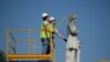 FILE - Houston city workers remove a statue of confederate soldier Dick Dowling from Hermann Park on June 17, 2020 in Houston, Texas.