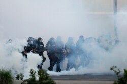 Police move toward demonstrators, May 31, 2020, in Minneapolis. Protests continued following the death of George Floyd, who died after being restrained by Minneapolis police officers on May 25.