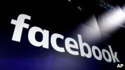 FILE - Facebook's logo is displayed at the Nasdaq MarketSite in New York, March 29, 2018. Facebook on Feb. 14, 2020, decided to allow a type of paid political message that sidesteps many of the social network's rules governing political ads.