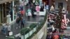 FILE- People shop at the Pentagon City Mall in Arlington, Virginia, Dec. 22, 2017.