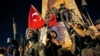 FILE - Turkish soldiers secure the area as supporters of Turkey's President Recep Tayyip Erdogan protest in Istanbul's Taksim Square during an attempted coup, July 16, 2016.