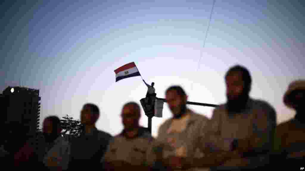 Egyptians pray among the crowds of protesters camped out in Tahrir Square. A top leader of the Islamist Muslim Brotherhood said the sit-in protest at Tahrir Square would continue until the decision to dissolve parliament is reversed.