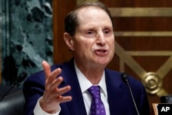 Ranking member of the Senate Finance Committee Sen. Ron Wyden, D-Ore., asks a question of Secretary of Commerce Wilbur Ross during a committee hearing on tariffs, on Capitol Hill, June 20, 2018, in Washington.