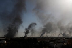 In this photo taken from the Turkish side of the border between Turkey and Syria, in Akcakale, Sanliurfa province, southeastern Turkey, smoke billows from targets inside Syria during bombardment by Turkish forces, Oct. 10, 2019.