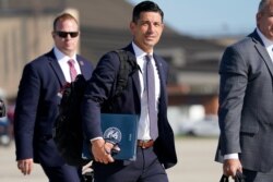FILE - Acting-Secretary of Homeland Security Chad Wolf, center, arrives to join President Donald Trump at Andrews Air Force Base in Md., Aug. 18, 2020.