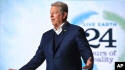 FILE - Former U.S. Vice President Al Gore hosts a 24-hour live webcast from the foot of the Eiffel Tower, in Paris, Nov. 13, 2015.
