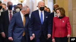 Prezidan Joe Biden mache ak Lide Sena a, Senate Demokrat Chuck Schumer, epi Prezidan La Chanm de Reprezantan an, Nancy Pelosi nan Washington, 6 Janv. 2022.