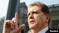 FILE - Former Peruvian president Alan Garcia talks to the media as he arrives at the National Prosecution office in Lima, Peru, March 27, 2018.