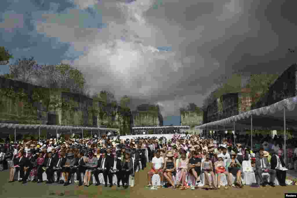 People pray during a minute of silence as part of a commemoration service for the 10th anniversary of the Bali bombing, Jimbaran, Bali, October 12, 2012.