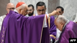 A cardinal sprinkles ashes on the head of Pope Francis during the celebration of Ash Wednesday Mass on Feb. 14, 2024, at the Basilica of Santa Sabina in Rome. (Vatican Media vis AFP)