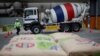 CarbonCure CEO and Founder Rob Niven standing with a CarbonCure system and branded concrete truck, April 19, 2021.