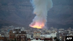 FILE - Smoke billows following an airstrike by the Saudi-led coalition targeting an arms depot in the Mount Noqum area on the eastern outskirts of Sana'a, Yemen, May 11, 2015. 