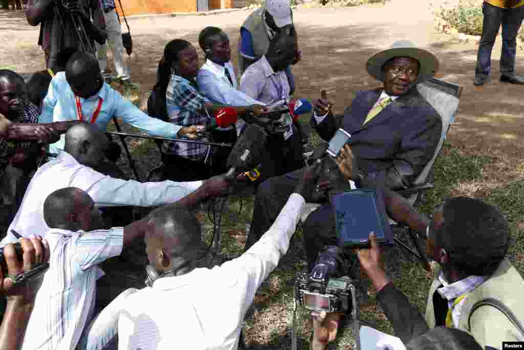 FILE - Uganda's incumbent President Yoweri Museveni speaks to the media soon after casting his vote at a polling station during the presidential elections in Kirihura, in western Uganda, Feb. 18, 2016.