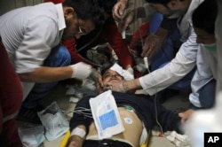 This photo released by the Syrian official news agency SANA shows a man receiving treatment at a hospital in Damascus, Syria, April. 7, 2018. State TV said Army of Islam fighters pelted several neighborhoods in Damascus with mortar shells, killing six civilians and wounding more than 30.