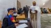 A woman looks at the election paper before voting in Ethiopia's general election, in Addis Ababa, Ethiopia, May 24, 2015. 