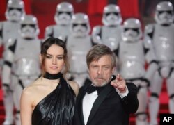 From left, Actors Daisy Ridley (who plays Rey) and Mark Hamill (Luke Skywalker) pose for photographers upon arrival at the premiere of the film 'Star Wars: The Last Jedi' in London, Dec. 12th, 2017.