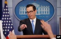 FILE - Treasury Secretary Steve Mnuchin gestures as he answers questions during a press briefing at the White House in Washington, Feb. 23, 2018. Mnuchin said sanctions announced March 15, 2018, "are a part of a broader effort to address the ongoing nefarious attacks emanating from Russia."
