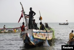 Fishermen land their boat at the beach near the coastal town of Joal-Fadiouth, Senegal, April 10, 2018.