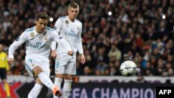 Cristiano Ronaldo, à gauche, tire un penalty lors du match contre le PSG au stade Santiago Bernabeu, Madrid, le 14 février 2018. 