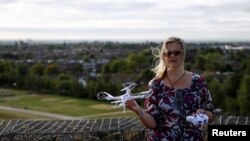Activist Linda Davidsen poses with a drone near Heathrow Airport in London, Sept. 12, 2019. 