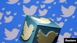 FILE - A 3-D-printed logo for Twitter is seen in this picture illustration, Jan. 26, 2016.