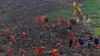 Rescuers recover 1 body and search for 28 people in a landslide in southwest China